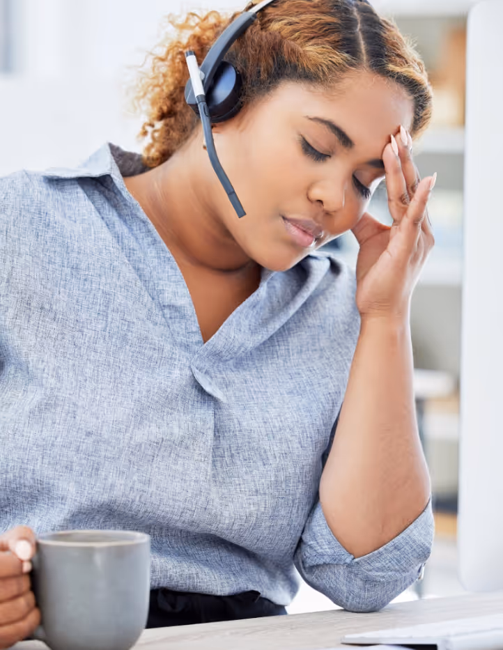 Overwhelmed clinician at workstation